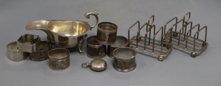 An Egyptian white metal sauceboat, a pair of George V silver toastracks, a late Victorian silver