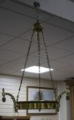 An Edwardian brass light fitting, made for electricity, lacking shade, drop 94cm, diameter