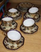 A Noritake porcelain part tea setCONDITION: Two of the tea cups have one hairline crack, another has