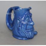 A C.H. Brannam blue glazed 'double mask' jug, height 15cmCONDITION: There is a glazed chip to the