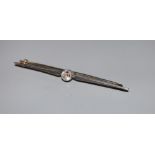 A white metal and solitaire diamond set bar brooch, 56mm, gross 3.3 grams.CONDITION: Diamond