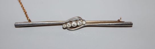 An early 20th century 15ct and graduated five stone diamond set bar brooch, 76mm, gross weight 5.7