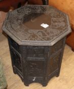 A Chinese carved octagonal ebonised table, W.56cm, H.58cm