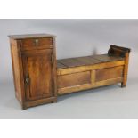 An early 19th century French oak box seat settle, with frieze drawer and cupboard flanking a box