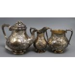 A Victorian embossed silver pear shaped three piece tea set, William Gough, Birmingham, 1863,