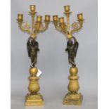 A pair of 19th century French bronze and ormolu candelabra, with scrolling branches, cherub stems