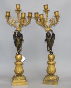 A pair of 19th century French bronze and ormolu candelabra, with scrolling branches, cherub stems