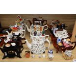 A collection of thirteen Portmeirion and Cardew novelty teapots, including dresser, sewing machine