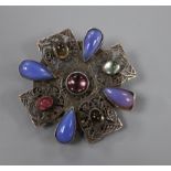 An early 20th century Arts & Crafts pierced white metal and cabochon stone set brooch, in the manner