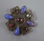 An early 20th century Arts & Crafts pierced white metal and cabochon stone set brooch, in the manner