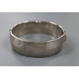 A 1970's textured silver hinged bracelet, with checkered decoration, by Rigby & Wilson, gross 46