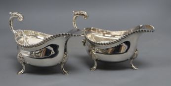 A pair of mid 20th century silver sauceboats, with flying scroll handles, I.S. Freeman & Co, London,