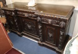 A late Victorian carved oak inverse breakfront sideboard, W.194cm., D.62cm, H.96cm