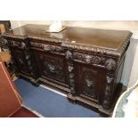 A late Victorian carved oak inverse breakfront sideboard, W.194cm., D.62cm, H.96cm