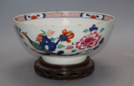 An 18th century Chinese verte Imari bowl on wood stand, c.1740, diameter 26cmCONDITION: There is a