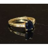 A modern 18ct gold and oval cut sapphire ring, with diamond set shoulders, size M, gross weight 3.
