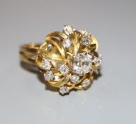 A modern 18ct and diamond set raised cluster dress ring, size N, gross 8.6 grams.CONDITION: No