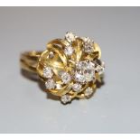 A modern 18ct and diamond set raised cluster dress ring, size N, gross 8.6 grams.CONDITION: No