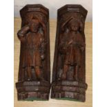 A pair of Italian carved oak figural wall shelves, length 42cm