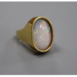 A modern 18ct gold and oval white opal set dress ring, size J, gross 8.4 grams.CONDITION: Stone