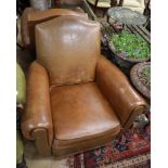 A pair of brown leather club armchairs