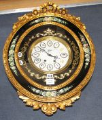 An ornate gold and floral painted electric wall clock, W.48cm H.68cmCONDITION: Two of the numbers