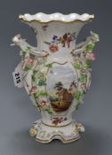 A late 19th century English bone china double handled vase, encrusted with flowers and having