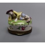 A Continental porcelain snuff box, modelled as a recumbent shepherd, height 6.5cm