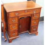 A George III mahogany kneehole desk, W.75cm., D.44cm., H.77cm.