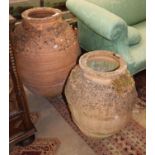 Two earthenware oil jars, largest H.76cm