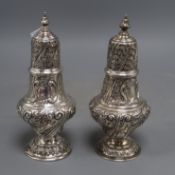 A pair of Edwardian repousse silver sugar casters, Sibray, Hall & Co, London, 1903/4, 20cm, 12.5