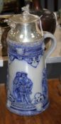 An early 20th century blue glazed German stoneware flagon, with silver plated griffon head mount,