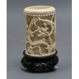 A Chinese carved and pierced ivory 'dragon' vase, wood stand, overall height 11.5cm