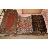 A Turkish red ground mat and two others, largest 64 x 53cm