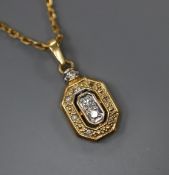 A modern yellow metal (stamped 750) and diamond set pendant, 13mm, on an unmarked yellow metal