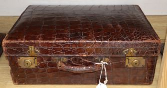 A crocodile skin suitcase, by Barkers, KensingtonCONDITION: The lid has several areas of