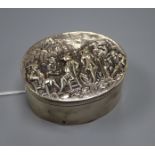 A George III silver oval box with hinged cover embossed with gentleman socialising, indistinct