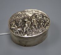 A George III silver oval box with hinged cover embossed with gentleman socialising, indistinct