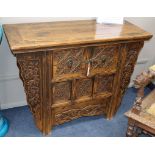 A Japanese carved elm and pine cabinet, W.105cm., D.46cm., H.83cm