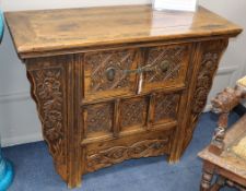 A Japanese carved elm and pine cabinet, W.105cm., D.46cm., H.83cm