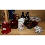 Three Regency gilt decorated blue glass spirit decanters, a Victorian cranberry glass hand bell