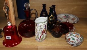 Three Regency gilt decorated blue glass spirit decanters, a Victorian cranberry glass hand bell