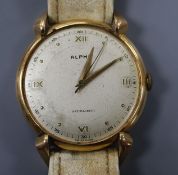 A gentleman's Swiss 750 yellow metal Alpha manual wind wrist watch, on associated strap, with case
