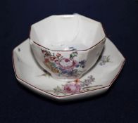 A Chelsea red anchor period octagonal tea bowl and saucer, c.1756, painted with floral sprays and