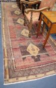 A Kazak red ground hall carpet, 430 x 138cm.