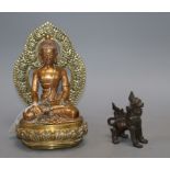 A Sino Tibetan bronze figure of Buddha Shakyamuni and a Thai lion dogCONDITION: The Buddha figure