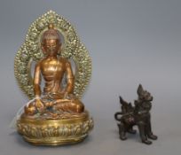 A Sino Tibetan bronze figure of Buddha Shakyamuni and a Thai lion dogCONDITION: The Buddha figure