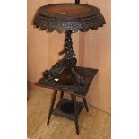 A 19th century Indian carved wood tripod table, Diam.64cm H.70cm and a similar square top two tier