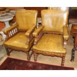 A pair of Victorian oak library chairs, upholstered in brown leather, W.68cm D.76cm H.102cm