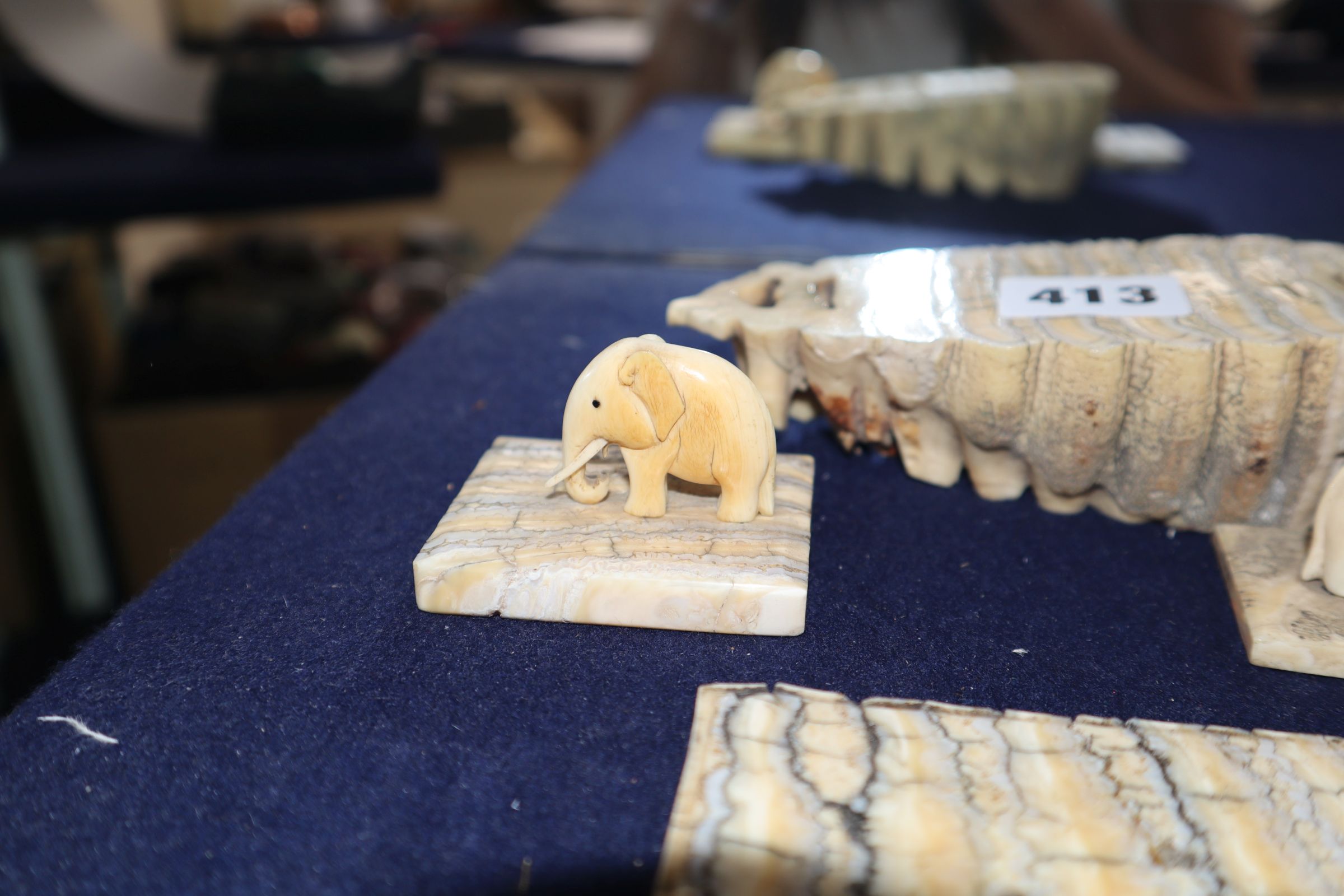 Two ivory elephant figures with elephant tooth stands and two elephant tooth specimens, early 20th - Image 3 of 6